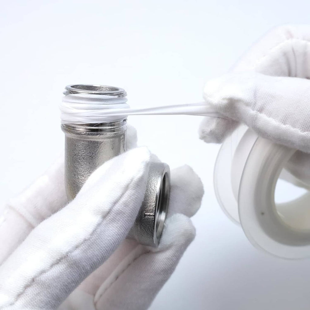 Stainless steel elbow pipe fitting installed with white PTFE tape on threads