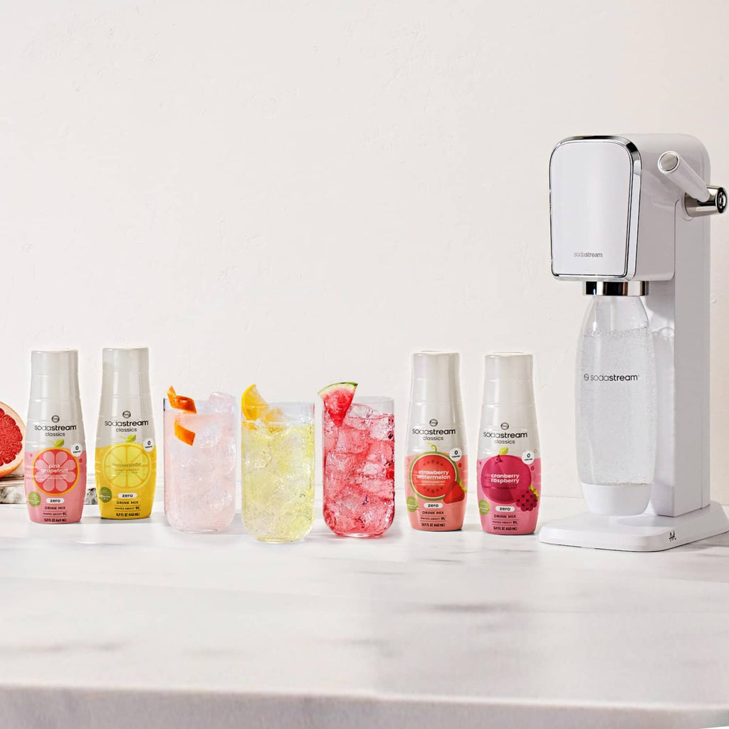 Sodastream drink mix cans lineup with carbonating machine