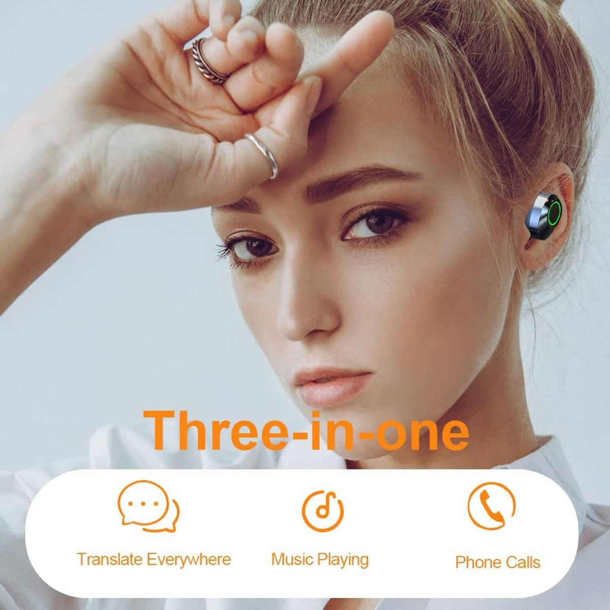 Black translation earbuds in ear on a woman, with green LED ring