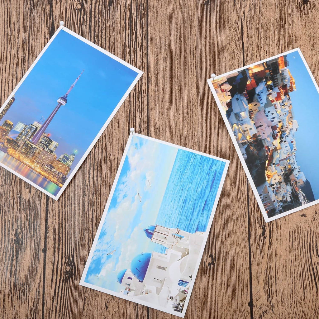 White push pins holding photos on a display board