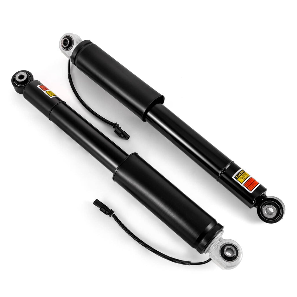 Side view of two black rear shock absorber struts with bottom eyelet mounts and wiring