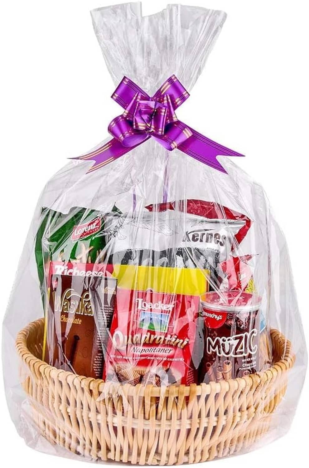 Large clear cellophane gift bag over a wicker basket with a purple satin bow
