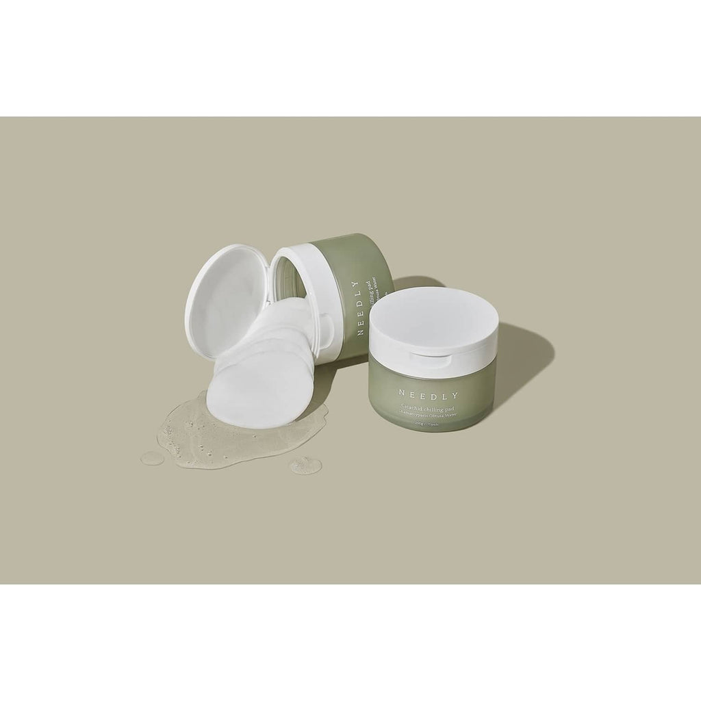 NEEDLY cleansing pad jar with open lid and pads spilling out