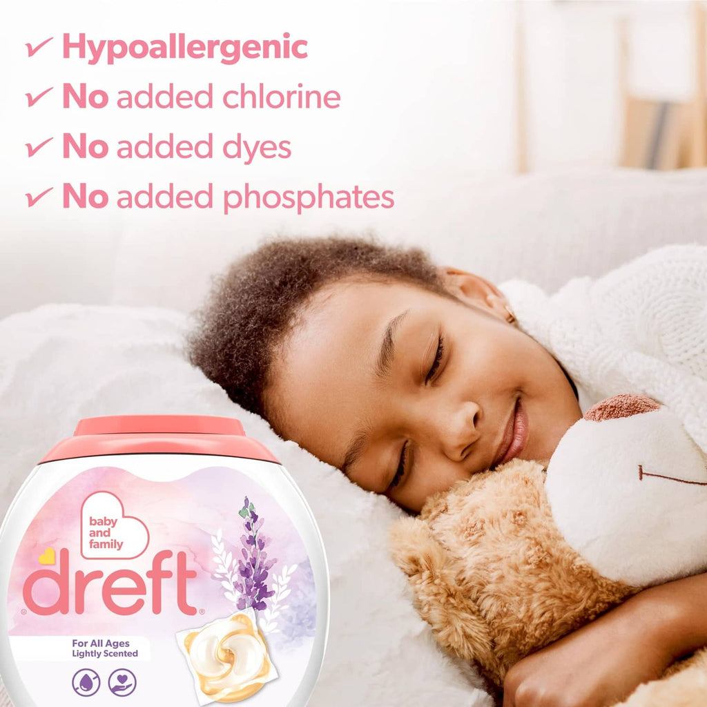 Dreft lightly scented detergent bottle beside a sleeping baby with teddy