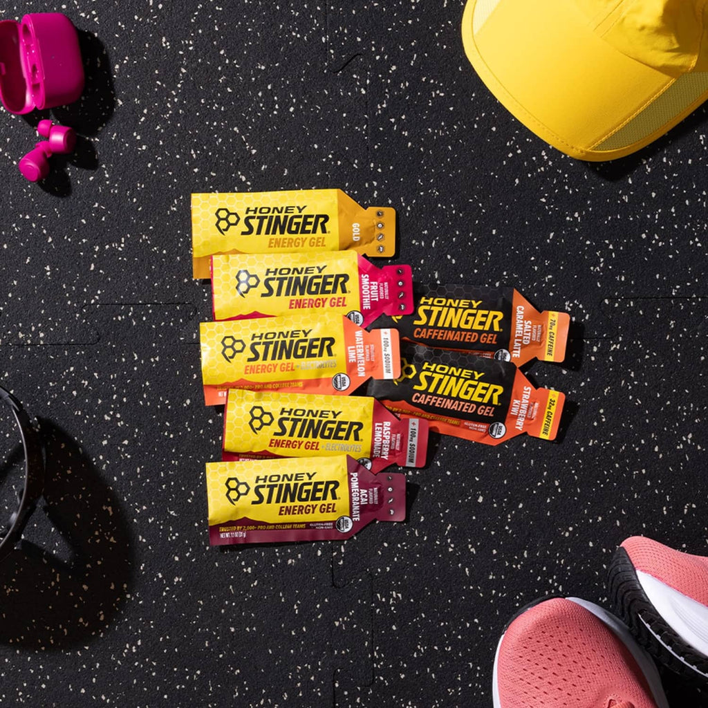 Honey Stinger energy gel packet assortment on a textured surface