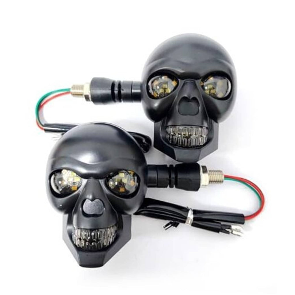 Pair of skull motorcycle turn signal lights with black housings, amber LEDs, and wired leads