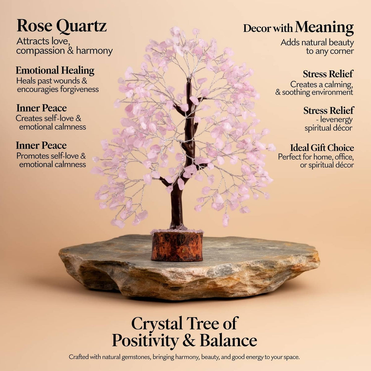 Rose quartz crystal tree with pink crystal branches and dark trunk on stone base