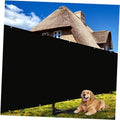 Black fence privacy screen netting with top grommet rows on outdoor fence.