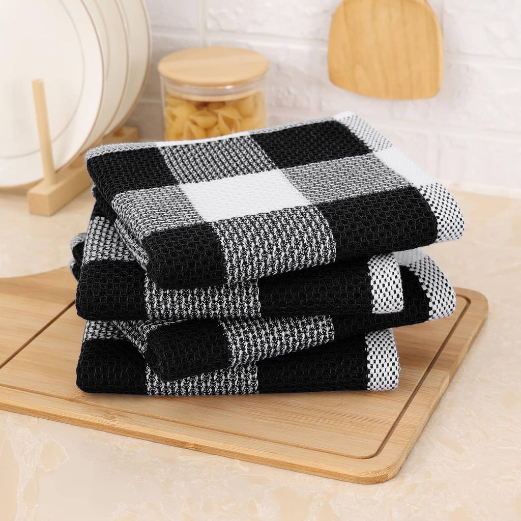Folded black and white check waffle weave dish towels, cotton texture stack