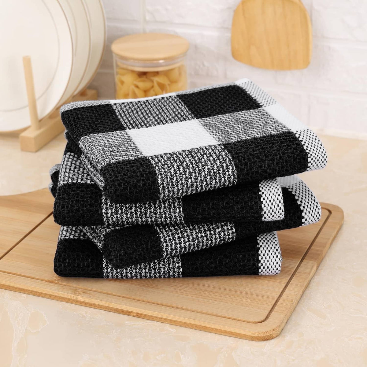 Folded black and white check waffle weave dish towels, cotton texture stack