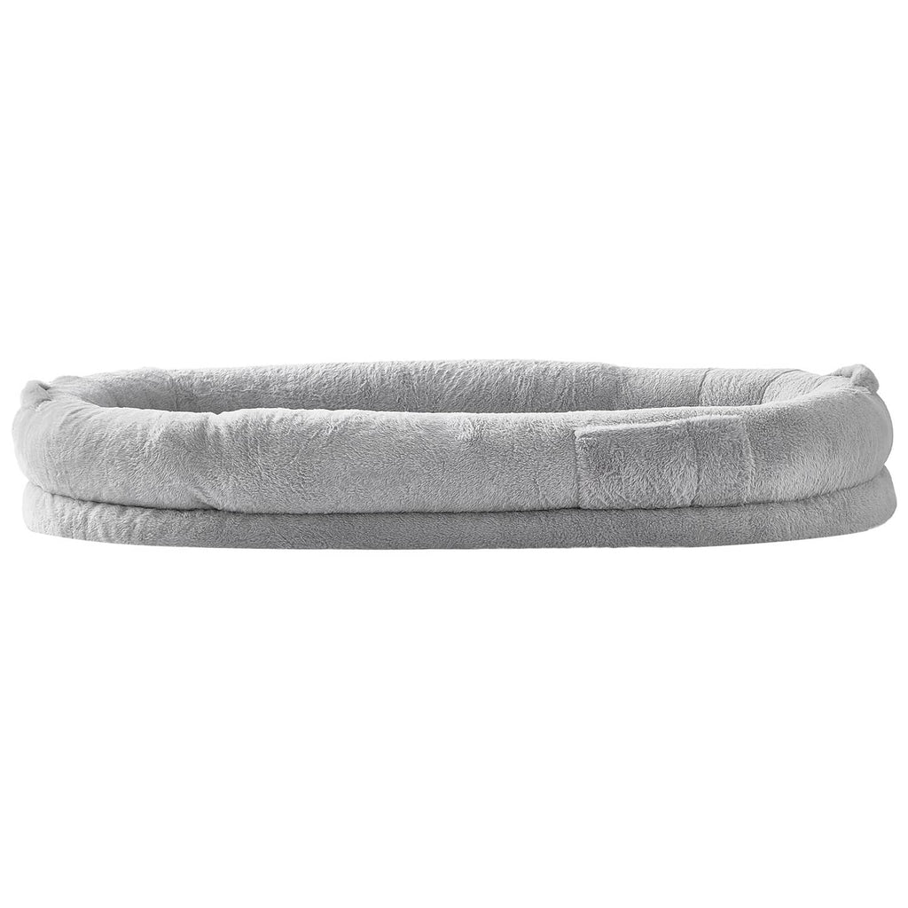 Grey oval dog bed profile with padded plush rim and smooth outer fabric.