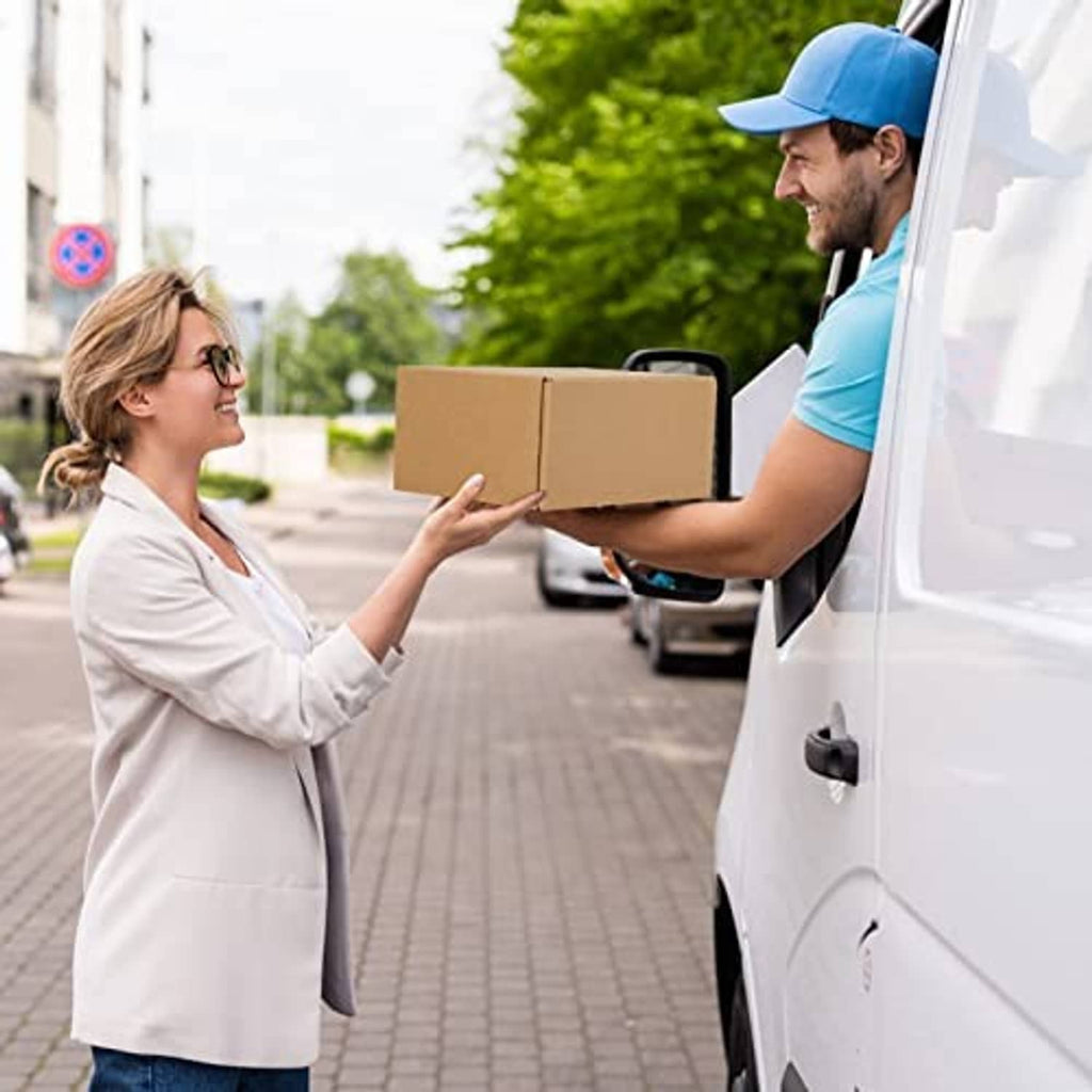 Corrugated shipping box held during delivery by a person at the door