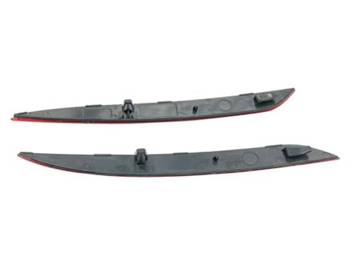 Pair of dark gray trim strips with red reflector lens inserts for rear bumper