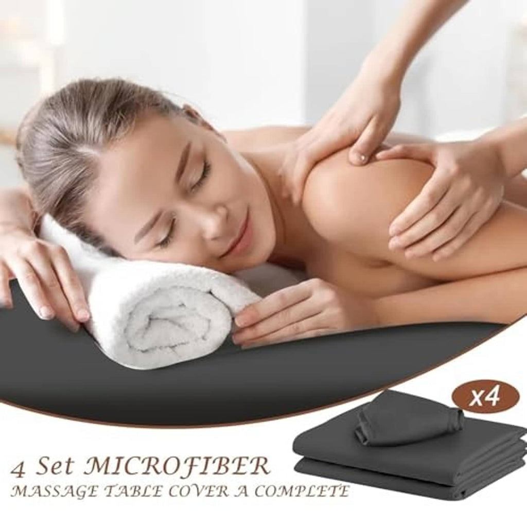 Dark gray massage table sheet with headrest cover in use during a massage
