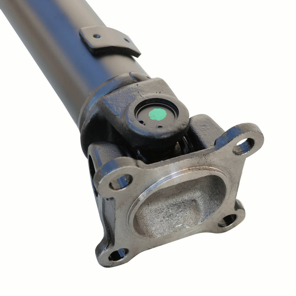 Front drive shaft yoke with mounting flange and black boot over steel shaft