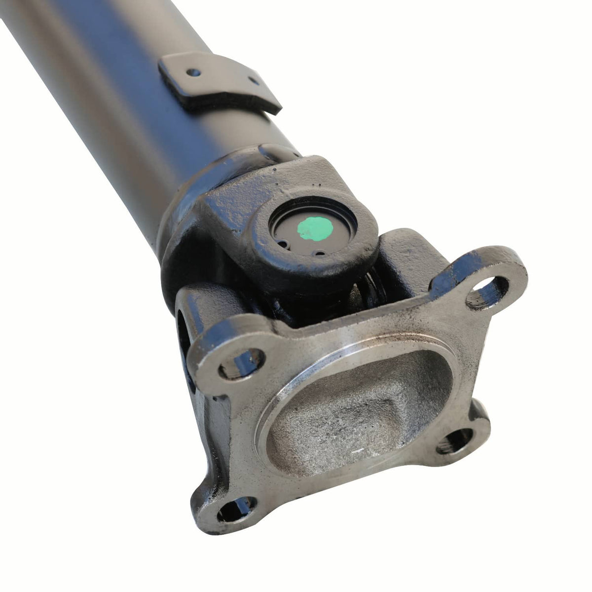 Front drive shaft yoke with mounting flange and black boot over steel shaft