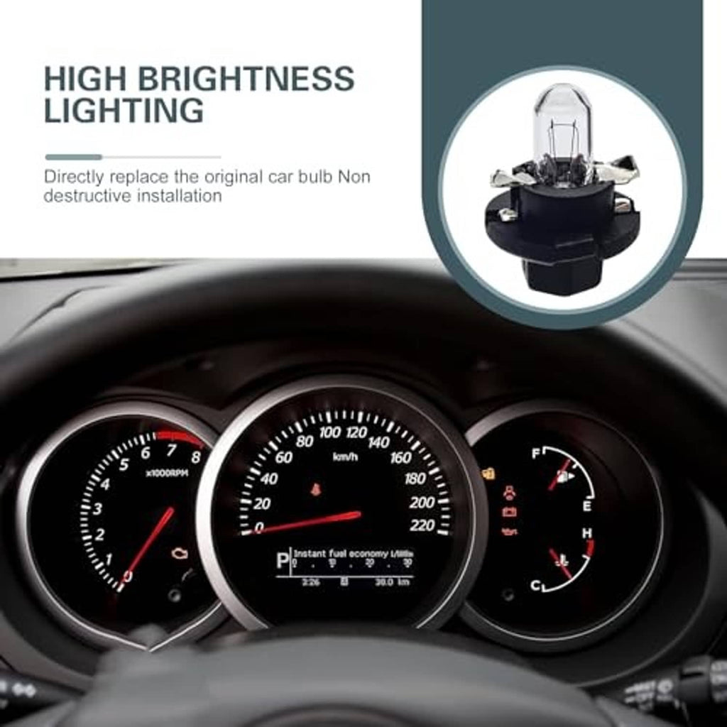 Clear glass dashboard light bulb positioned above an illuminated instrument cluster