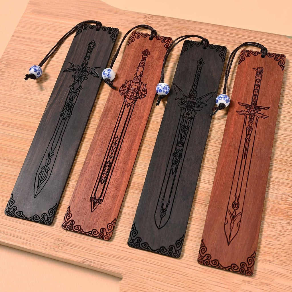 Four hanging sword bookmarks with bead ends, black and brown designs on wood surface