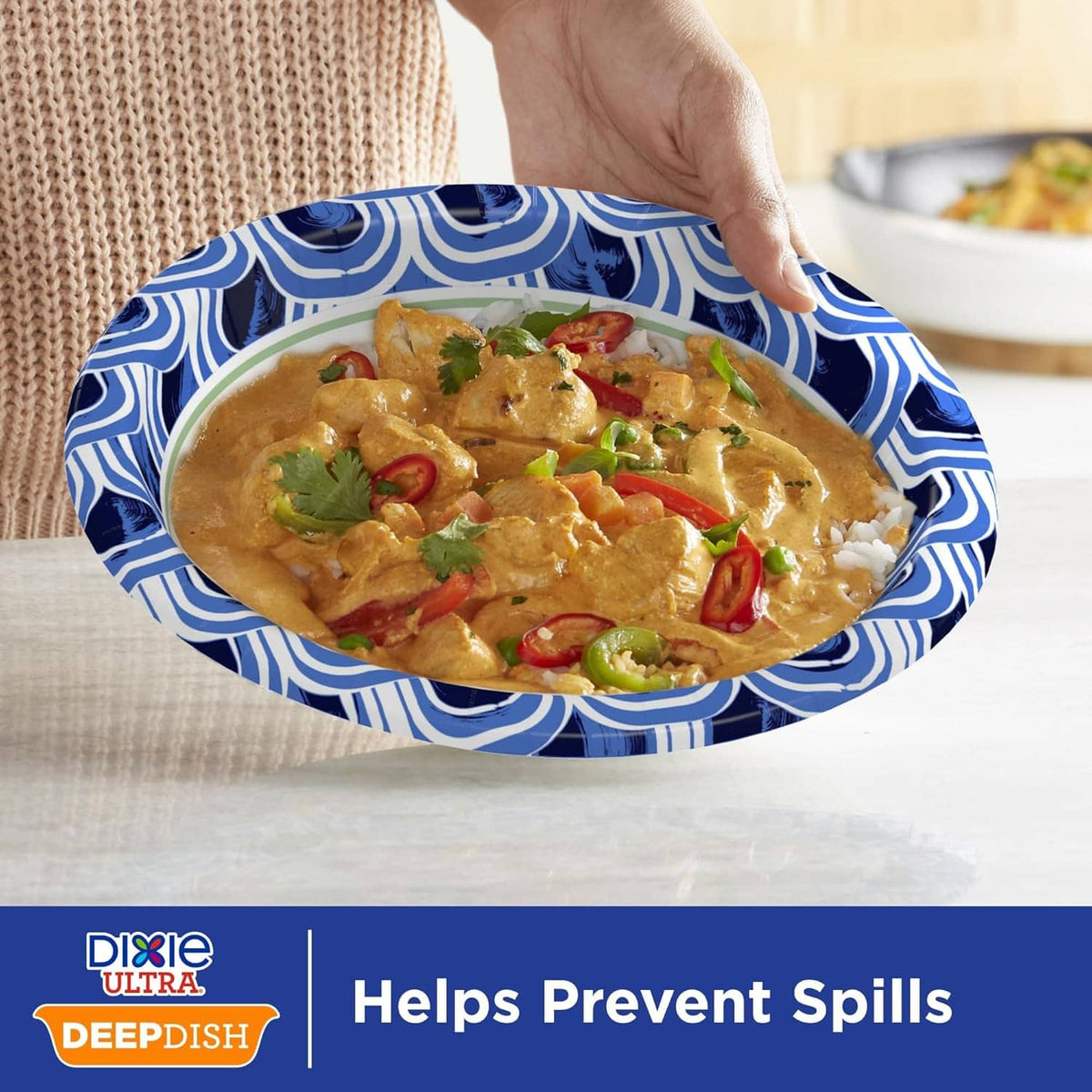 Blue patterned deep dish paper plate with curry and vegetables, wide rim