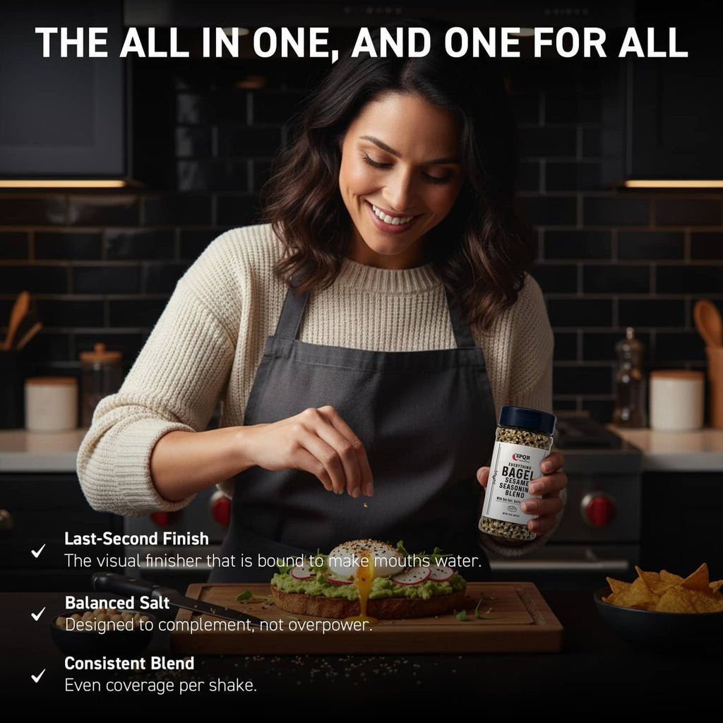 Everything bagel seasoning blend jar held in a kitchen scene, blue cap visible