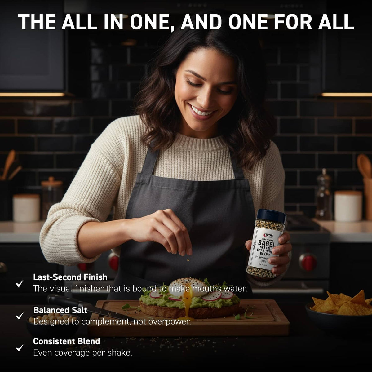 Everything bagel seasoning blend jar held in a kitchen scene, blue cap visible