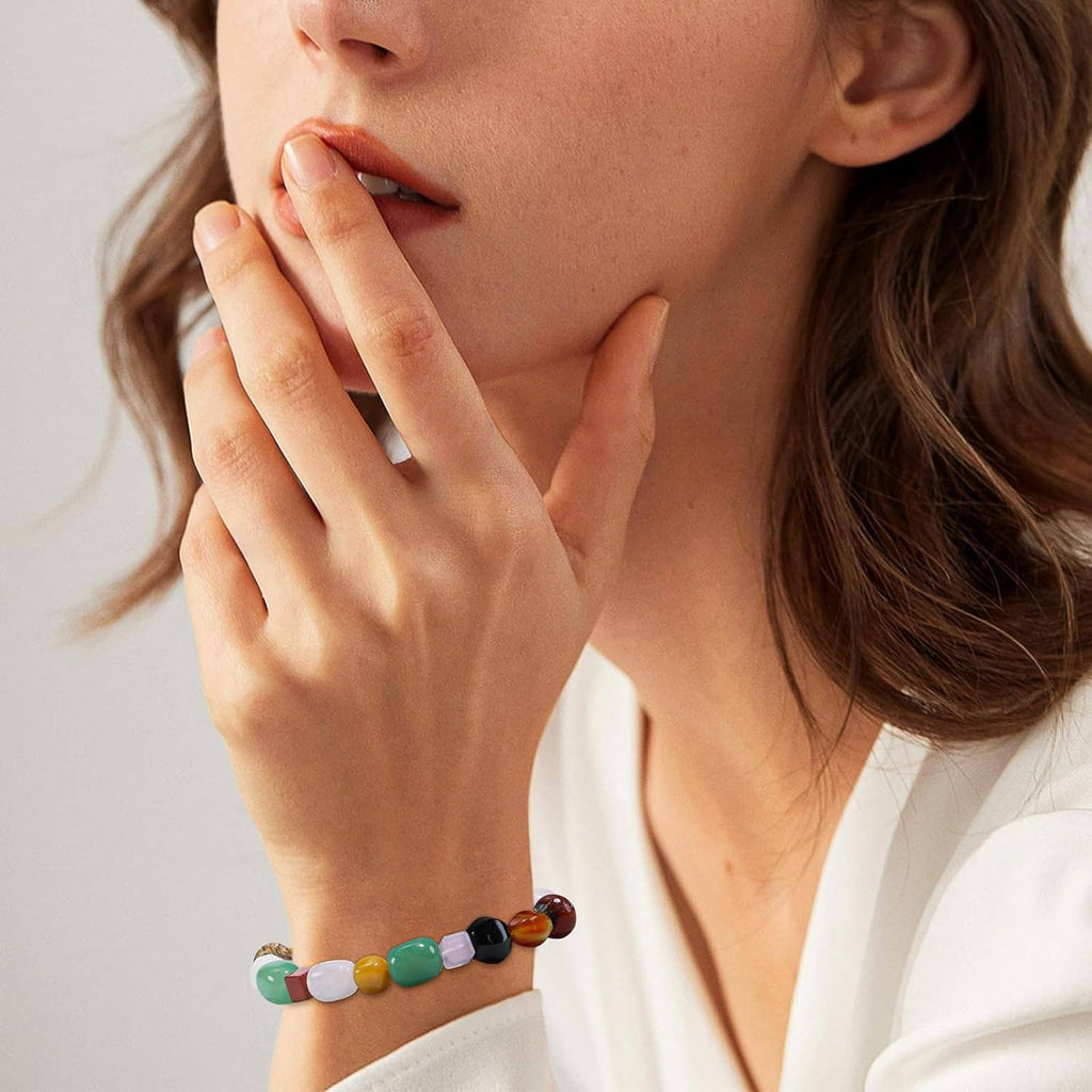 Multicolor natural stone bead bracelet on wrist, featuring round and oval beads