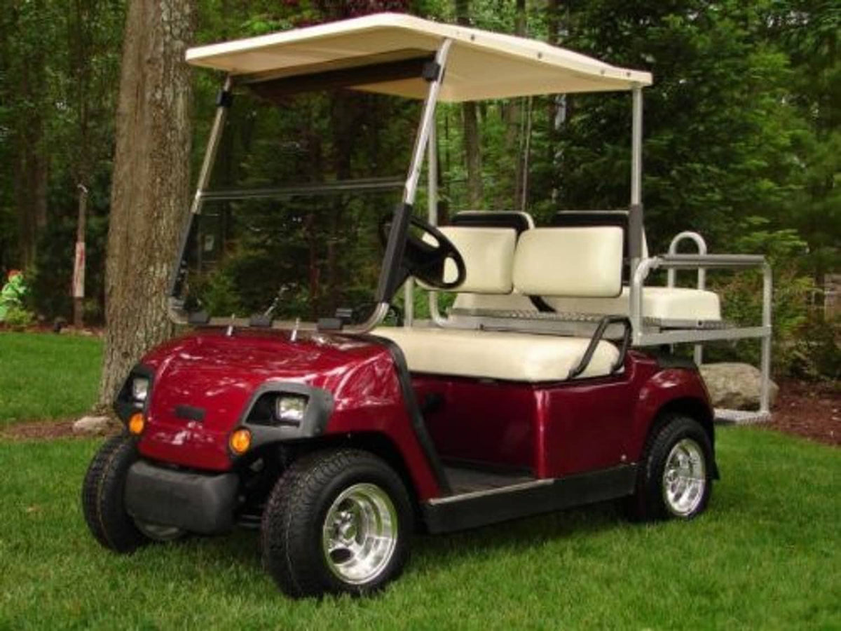 Tinted folding windshield installed on a golf cart near the seats