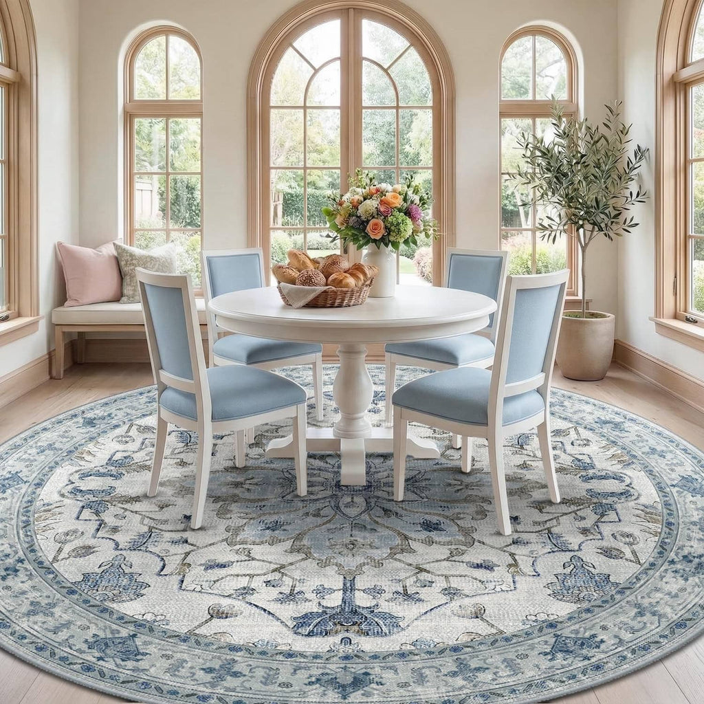 Round blue-and-gray area rug with ornate border and medallion, under dining table