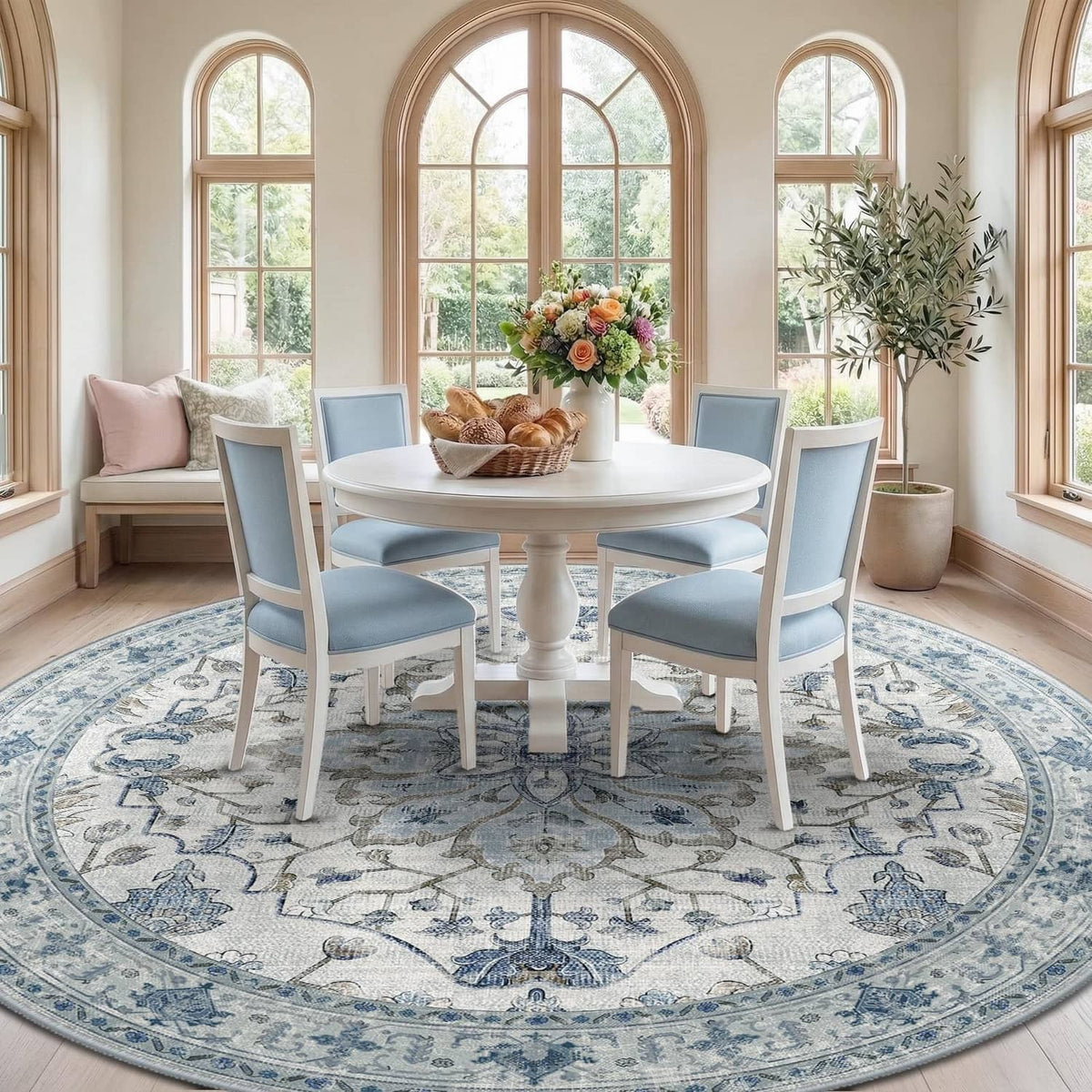 Round blue-and-gray area rug with ornate border and medallion, under dining table