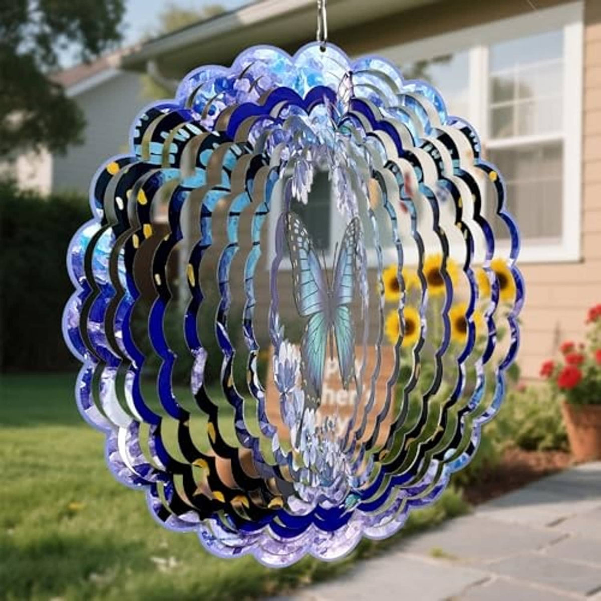 Hanging butterfly wind spinner viewed from side; layered blue and silver metal rings
