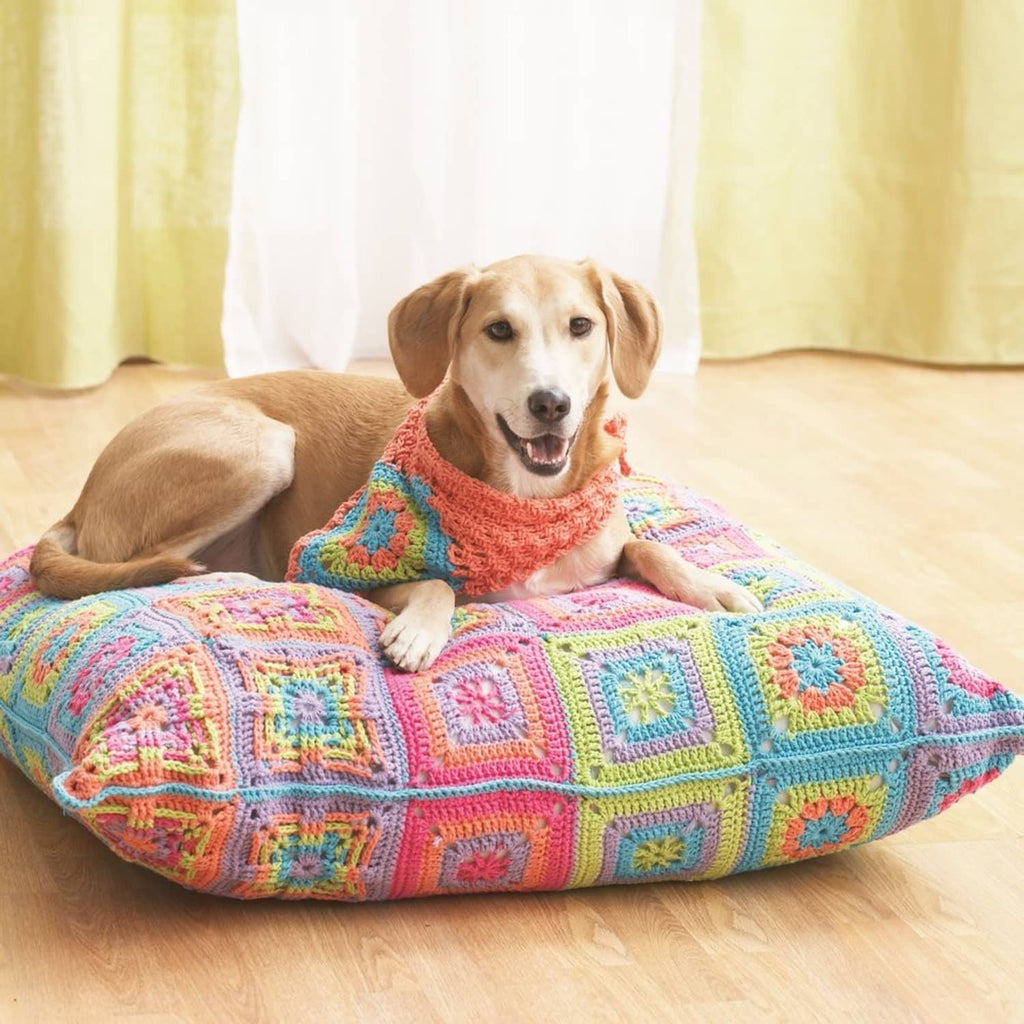 Multicolor crocheted dog bed with granny-square style pattern