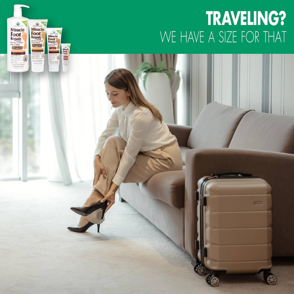 Foot repair cream with traveler sitting on couch beside a beige suitcase