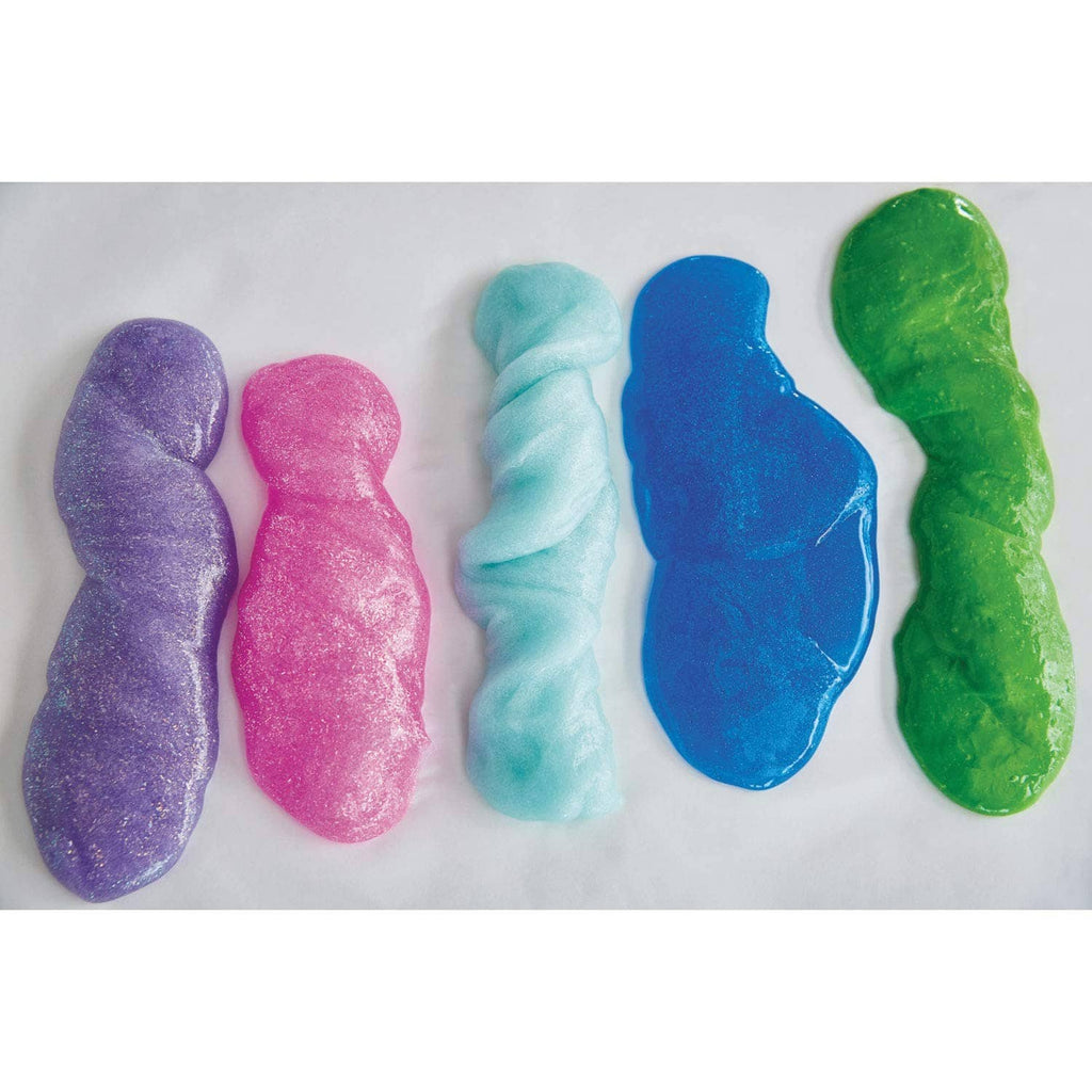 Colored slime samples on a surface: purple, pink, light blue, dark blue, green
