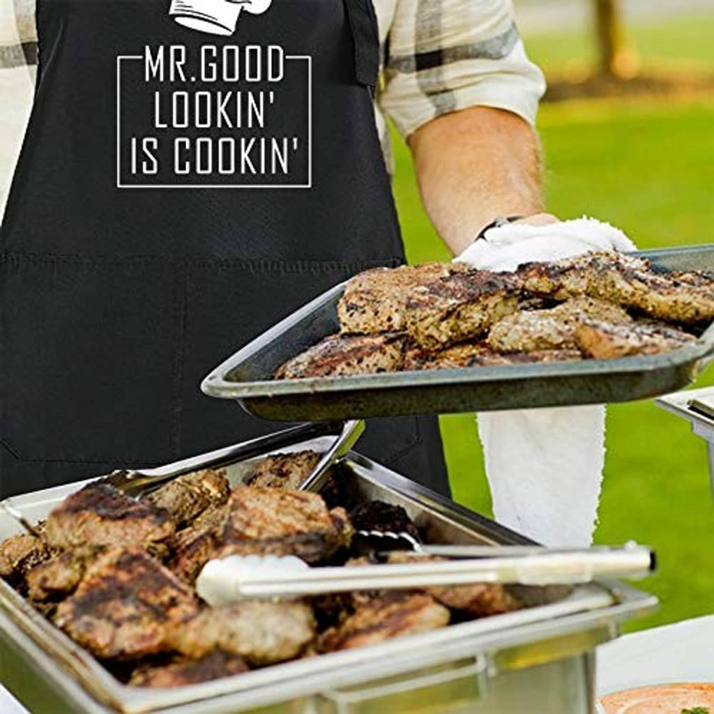 Black BBQ chef apron in use with "Mr. Good Lookin' is Cookin" logo