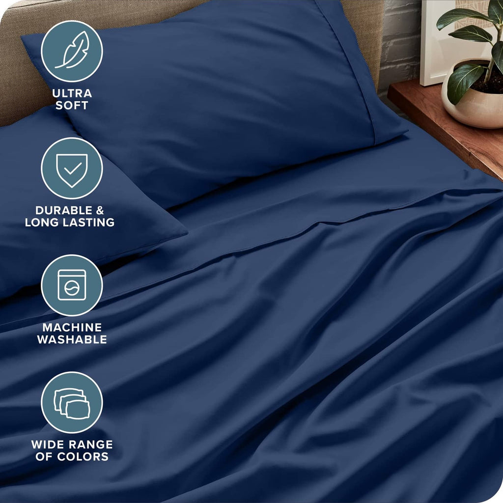 Dark blue bed sheet set fabric close-up with fitted sheet and pillowcases seams