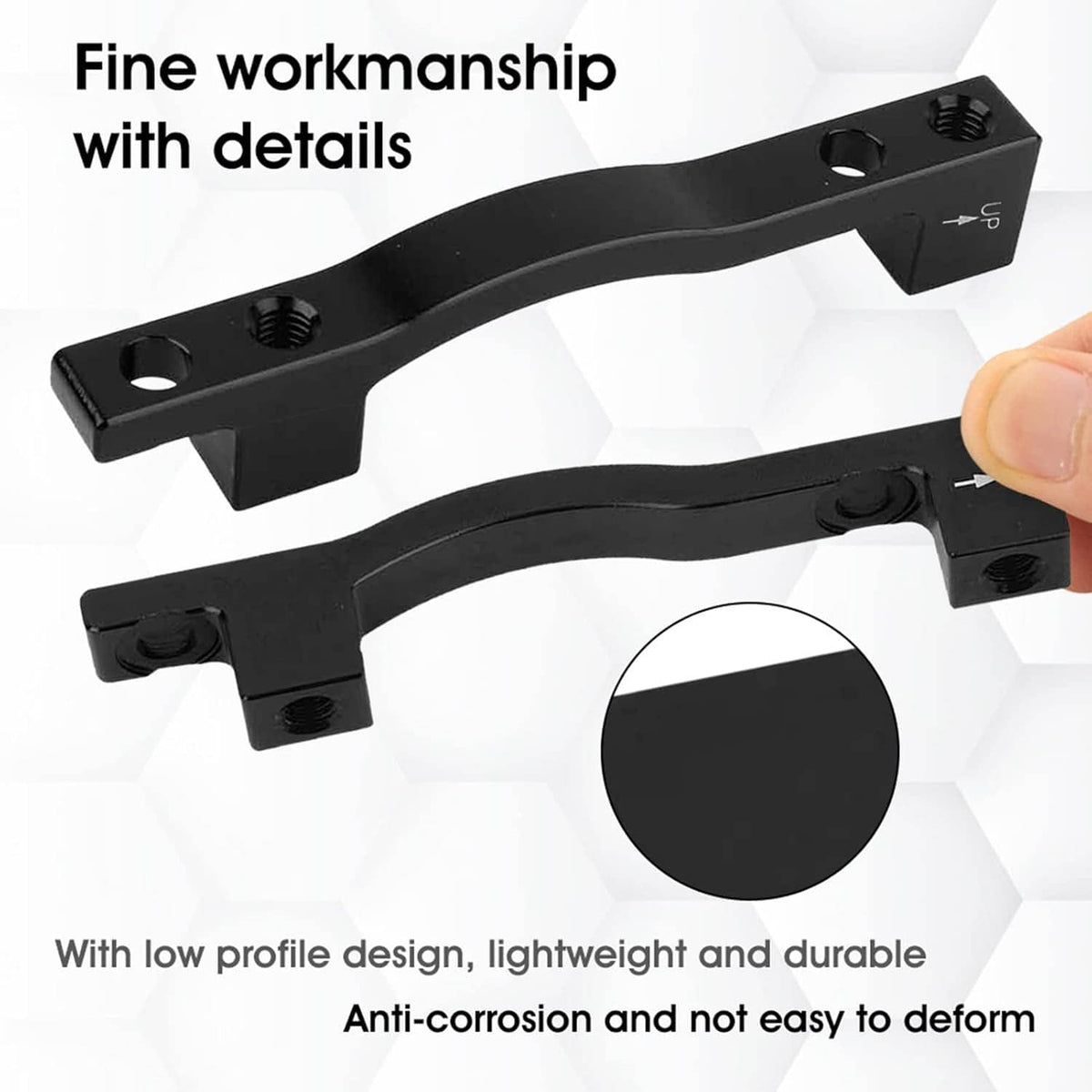 Pair of black low-profile brake adapter spacers with threaded holes, shown side by side