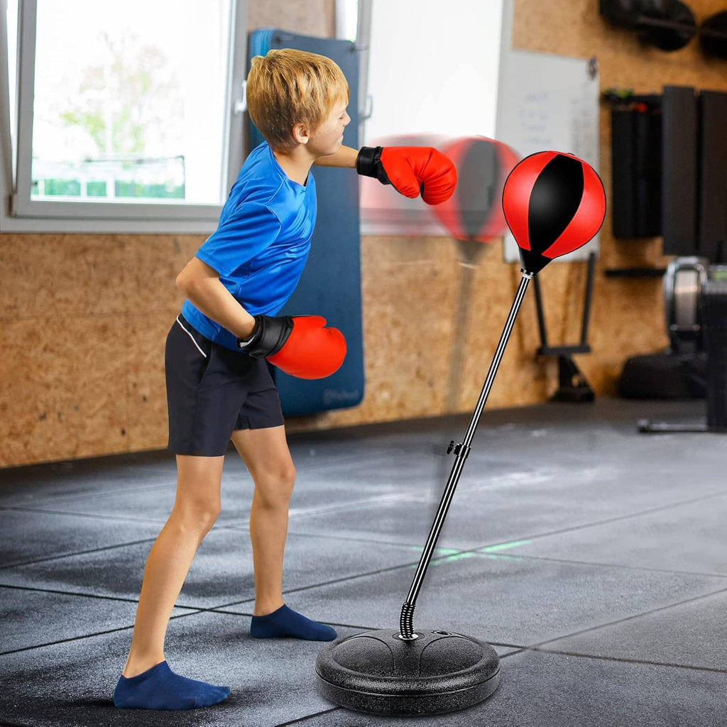 Child boxing with adjustable punching bag stand, red-and-black ball, and boxing gloves