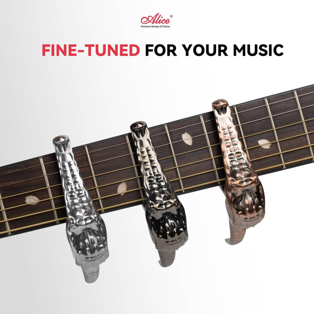 Set of three alligator-style guitar capos with metallic finish