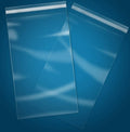 Clear self-sealing cellophane bags, small size, stack of bags