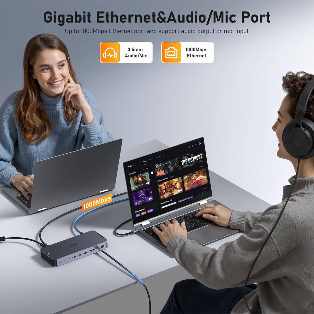 Gray docking station with Ethernet and audio/mic ports, shown with two laptops.