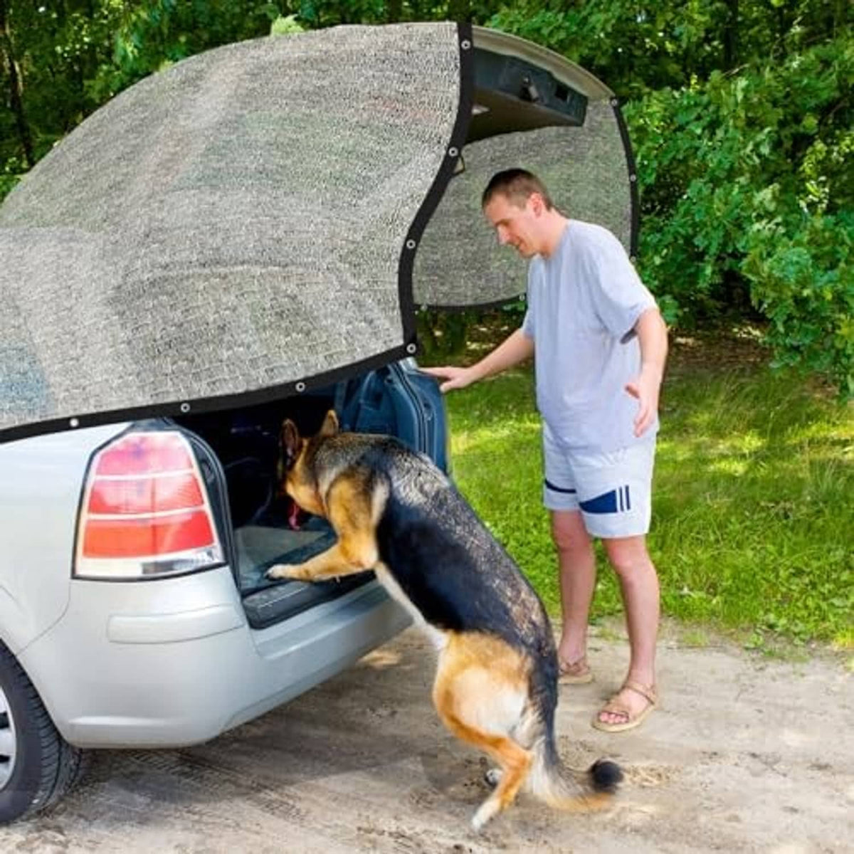 Gray shade cloth canopy with black grommets lifted open over a car