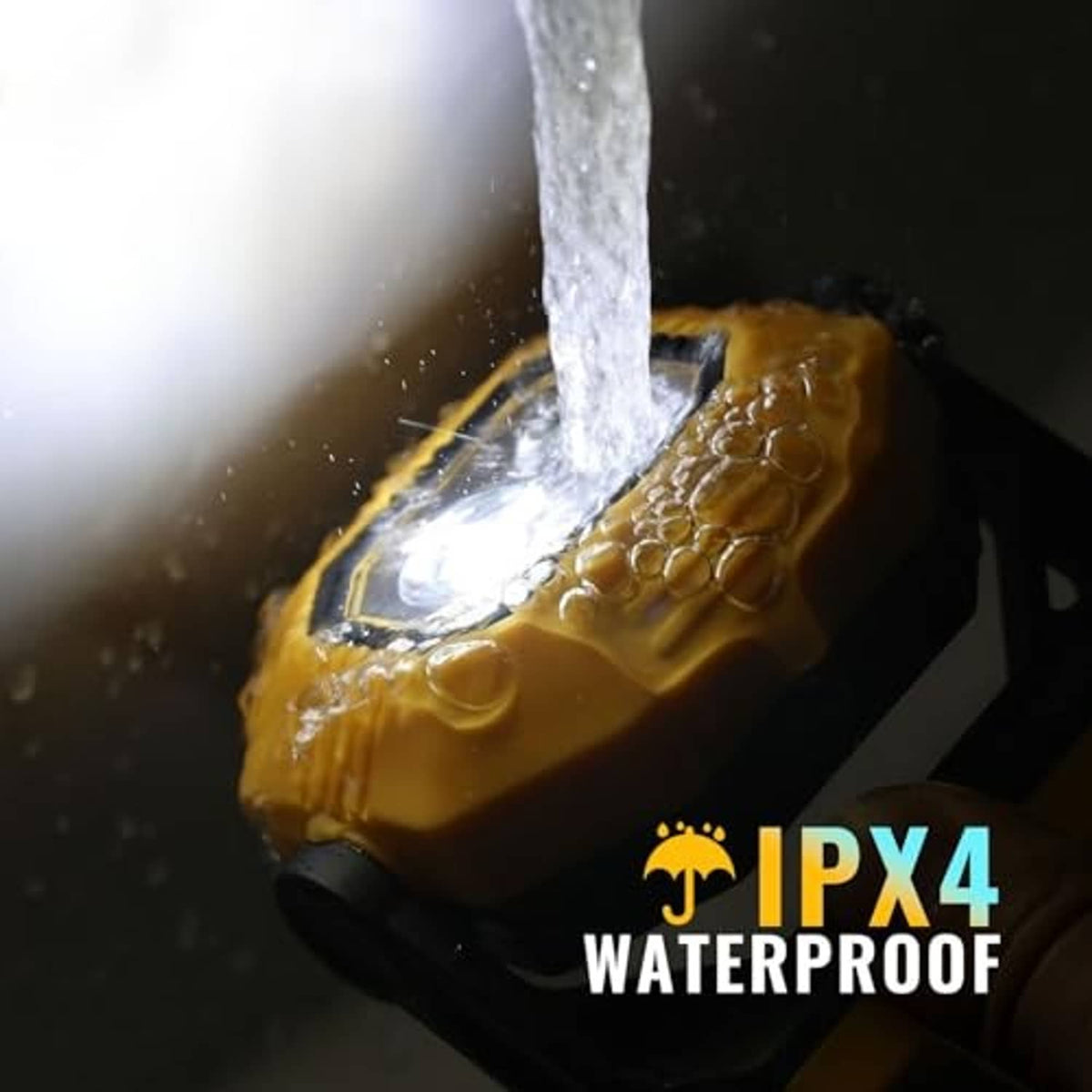 Orange rechargeable LED work light with water spray over the front LED head