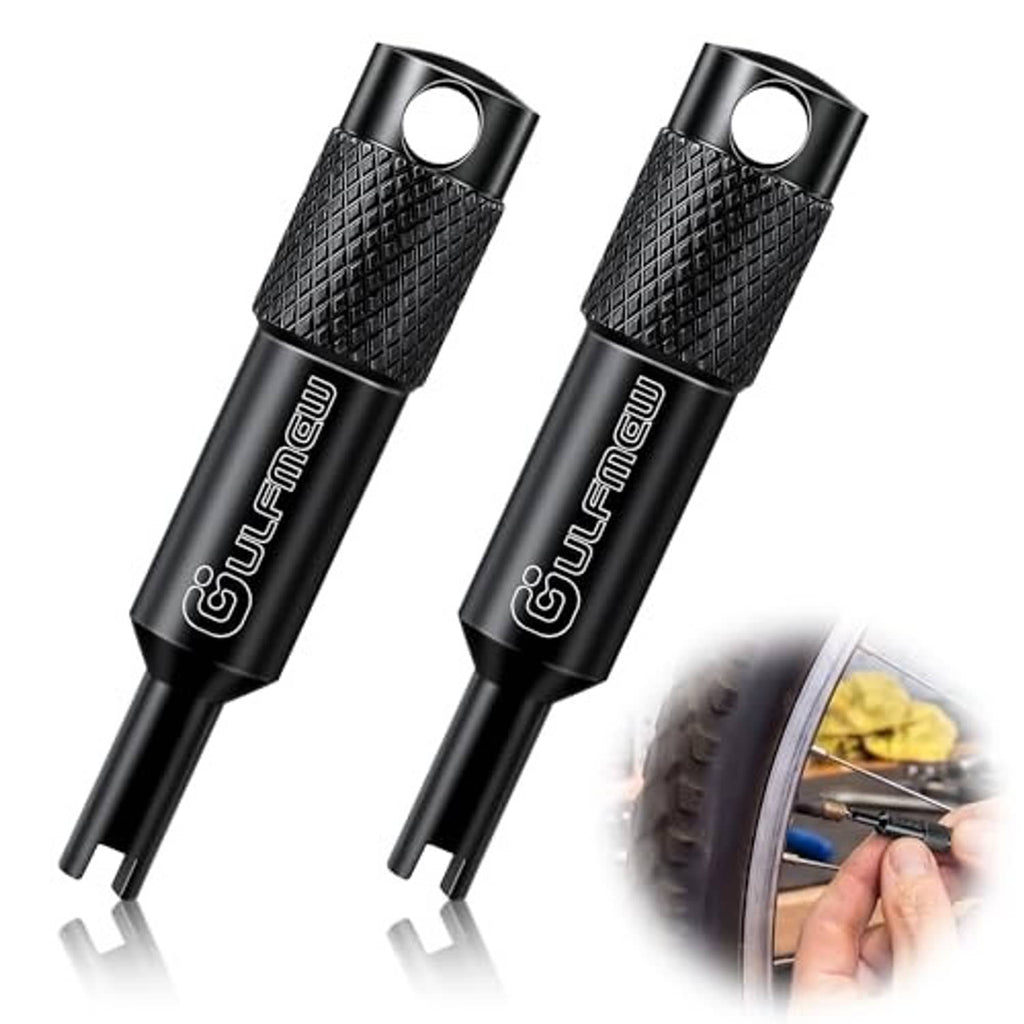 Two black valve core removal tools with textured grip and loop hole, angled view