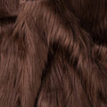 Brown faux fur fabric swatch with dense, long shag fibers texture close-up.