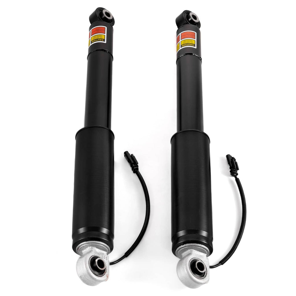 Front view of two black shock absorbers with lower silver mounts and attached wiring