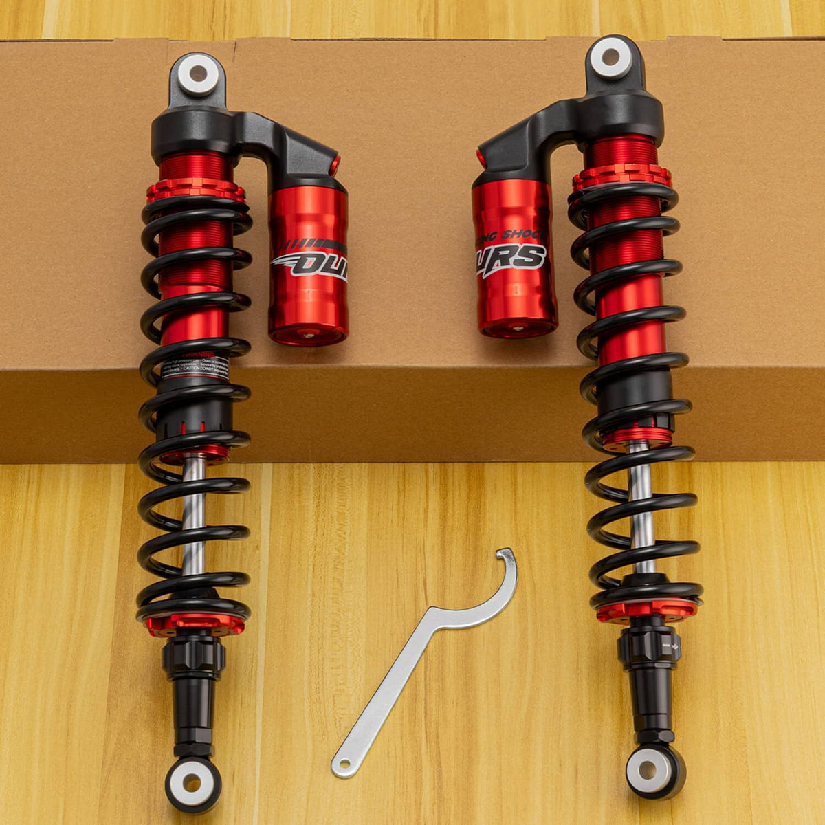 Rear air shock absorbers with red reservoirs and black coil springs with top mounts