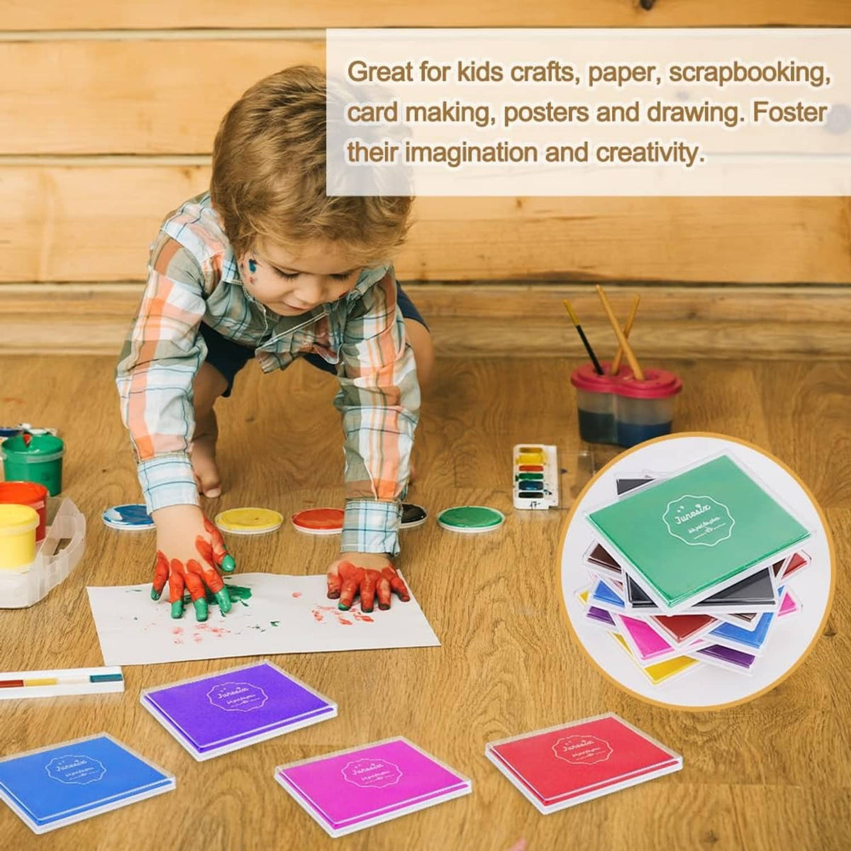 Child using colorful washable fingerprint ink pads on paper for crafts