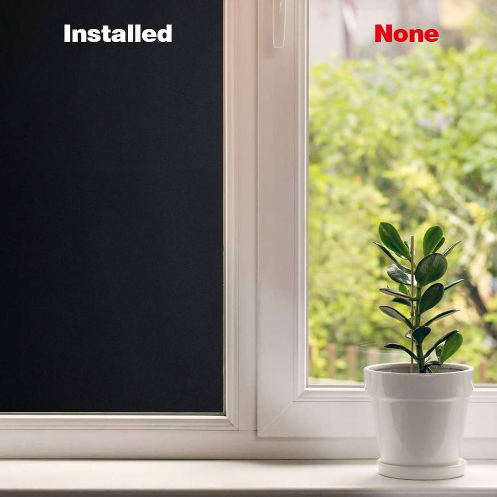 Dark blackout window film on window with indoor plant on sill, smooth surface