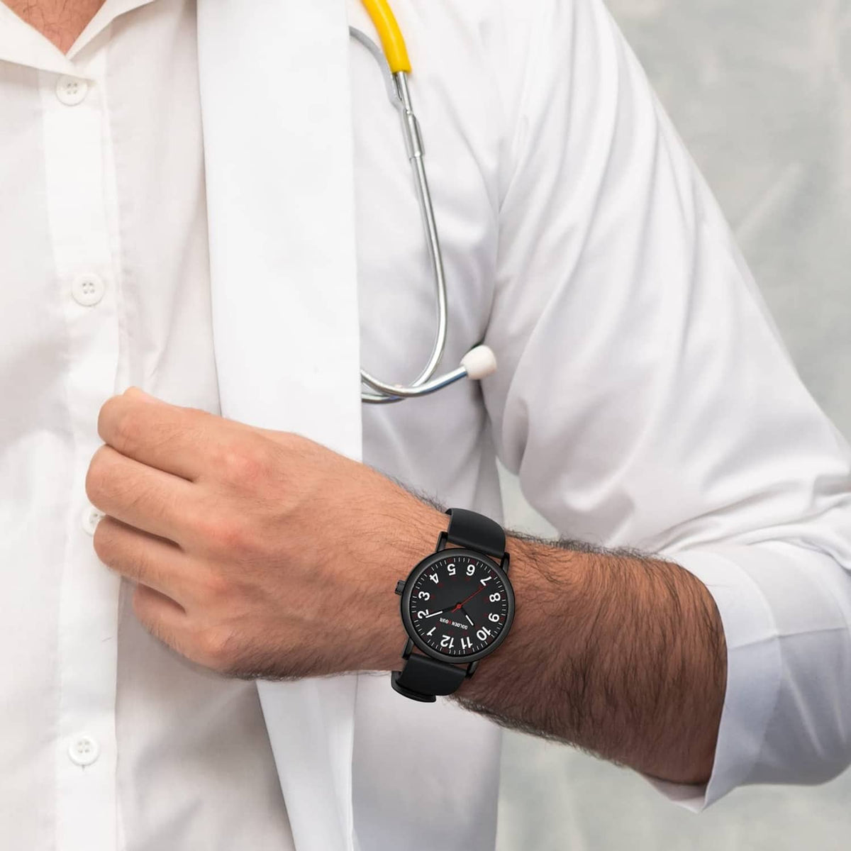 Black nurse watch worn on wrist with round dial and black silicone strap