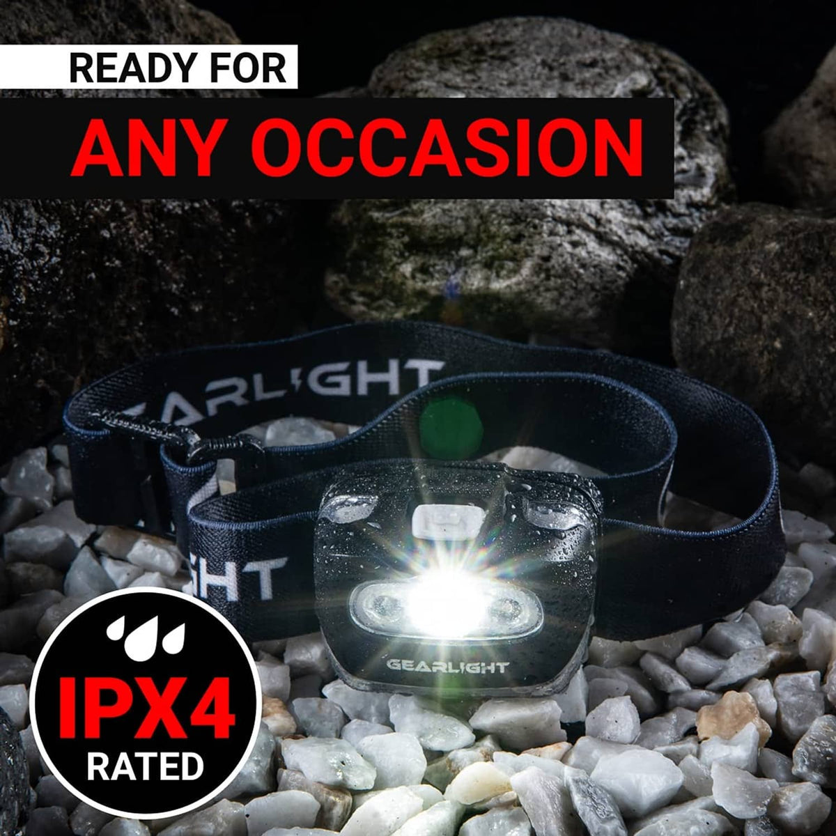 Black waterproof headlamp on rocky surface with bright white LED shining
